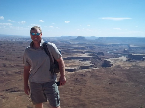 Photo of Jeremiah Unger with desert and canyons in the background.