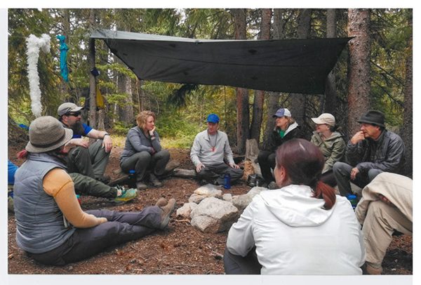 DCLF participants seated in a circle in the woods